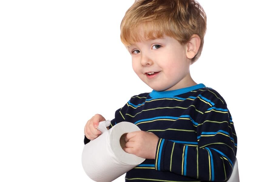 Young boy holding roll of toilet paper