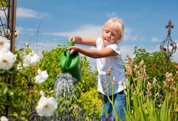 SpringActivities,Gardening,WateringFlowers,ChildWateringFlowers