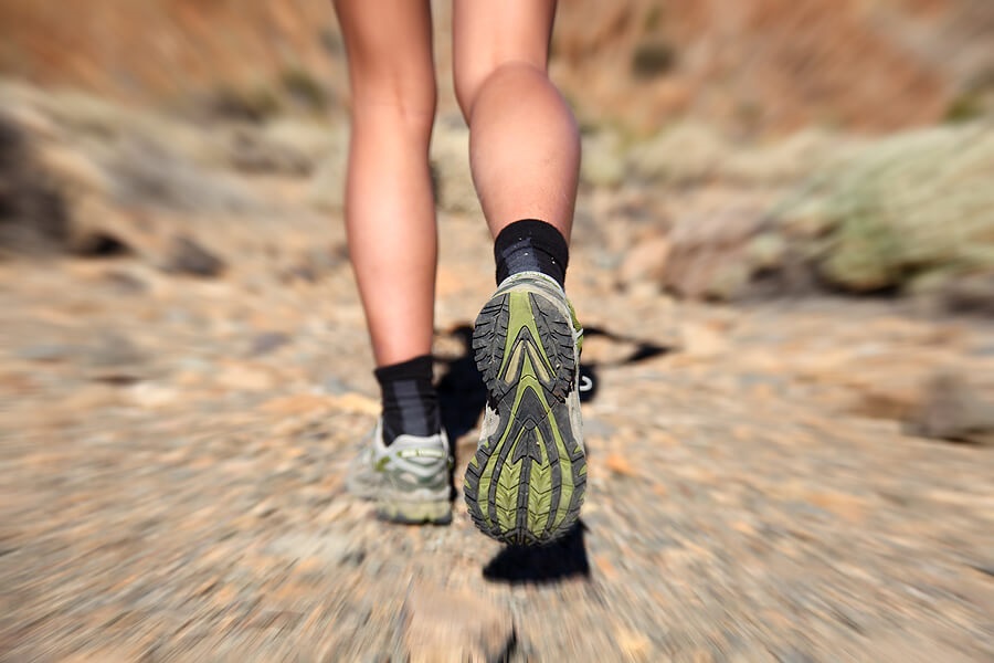 Close up of woman's running shoes on outdoor trail