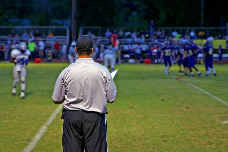 what colleges look for, football coach watching game