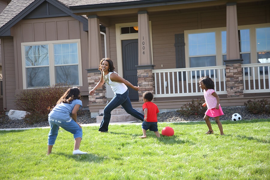 Fun Family Fitness, Mom and three kids playing ball or tag outdoors for exercise