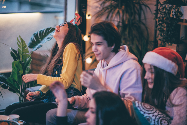 teens having fun new year's eve party after christmas