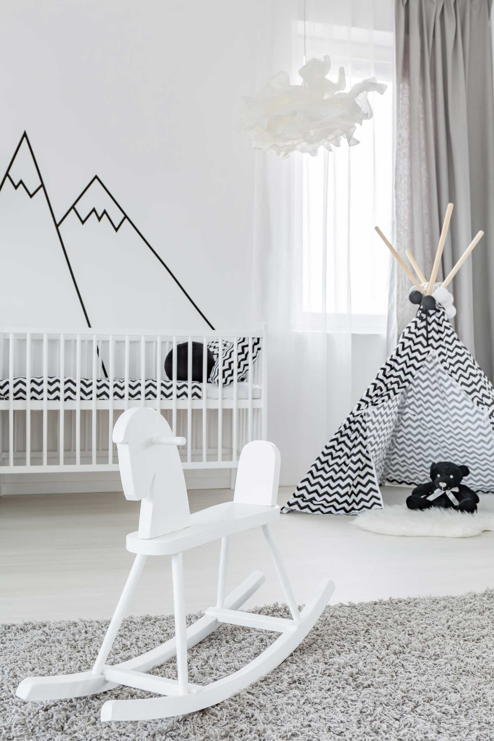 Baby girl room with white rocking horse and play tent