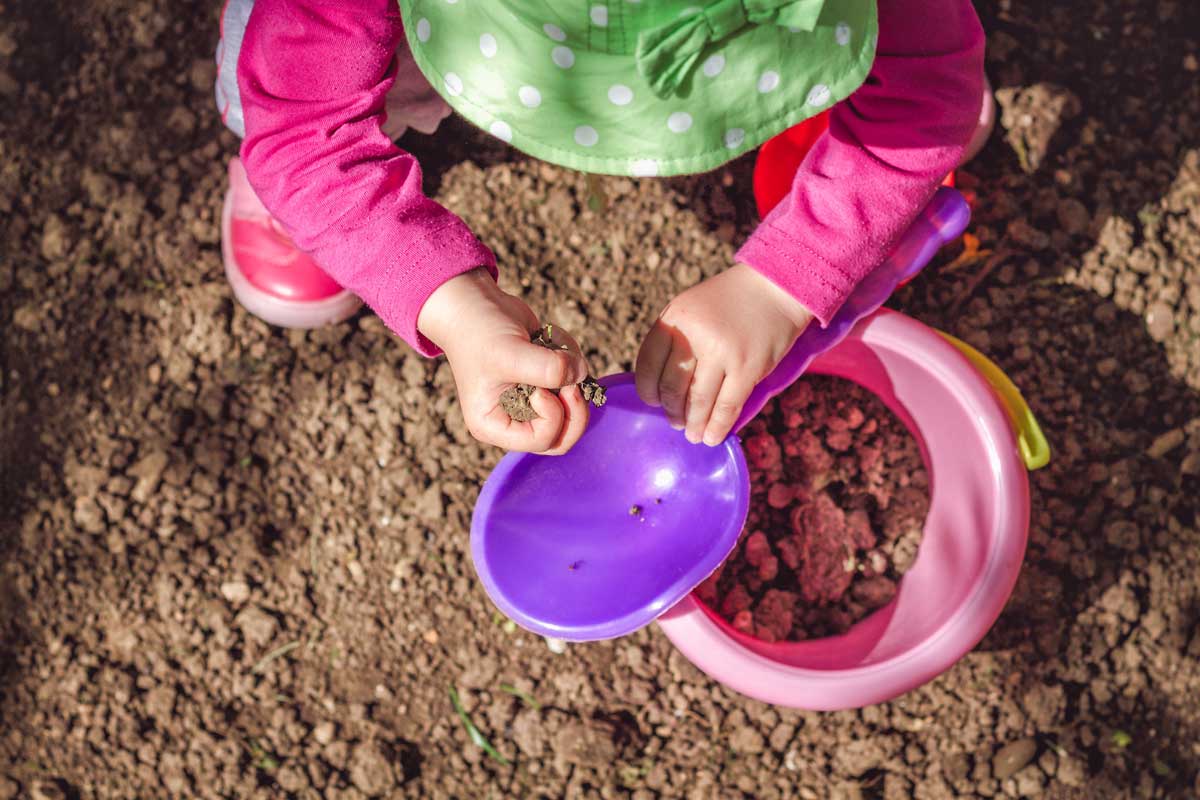 little girl playing in dirt