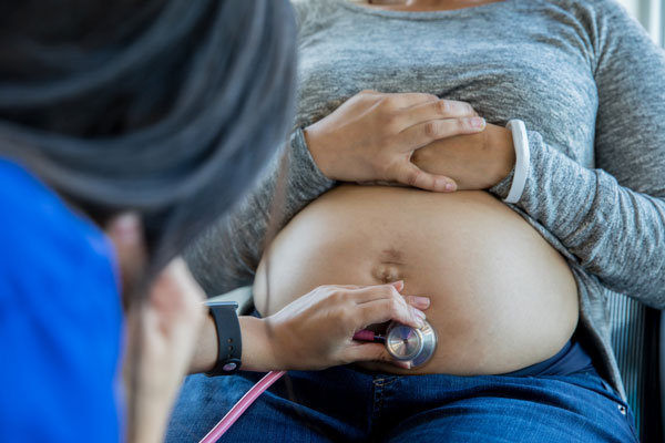 doctor checking on pregnant woman over 35