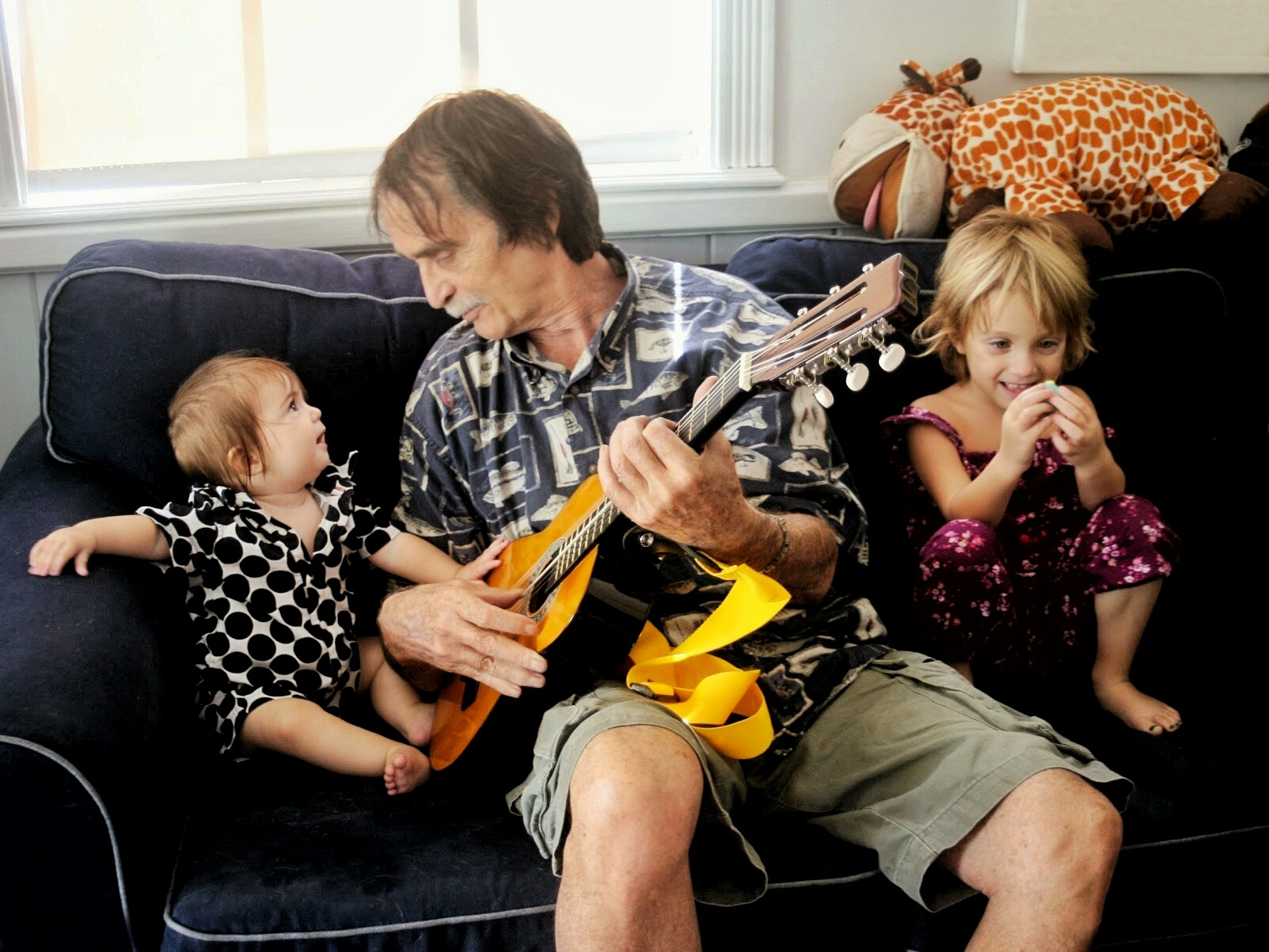 grandpa plays guitar rock n' roll for baby grandkids 