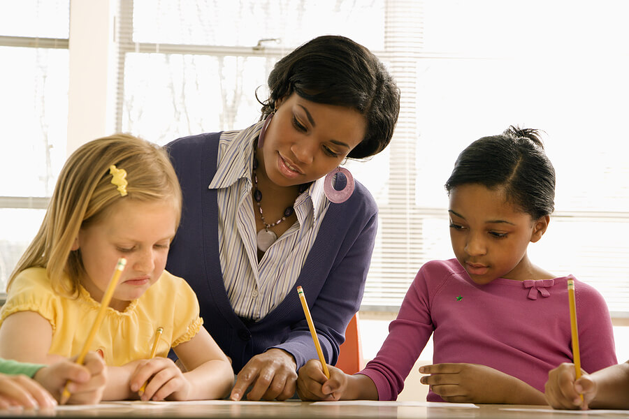 StrugglinginSchool,TeacherHelpingFirstGradeGirlsRead