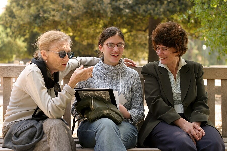 Three women talking on bench