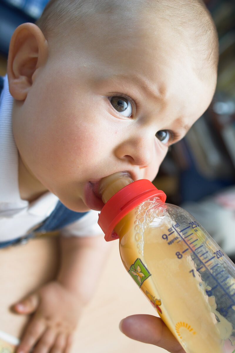 Baby nursing on bottle