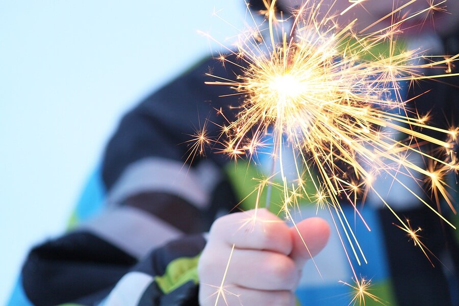 Close up of child holding sparkler in hand
