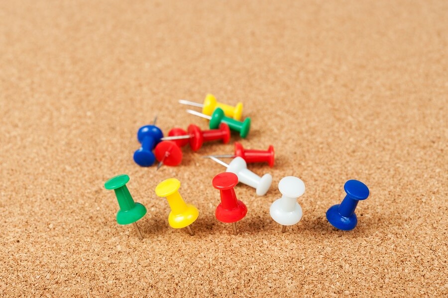 Bulletin board and thumb tacks