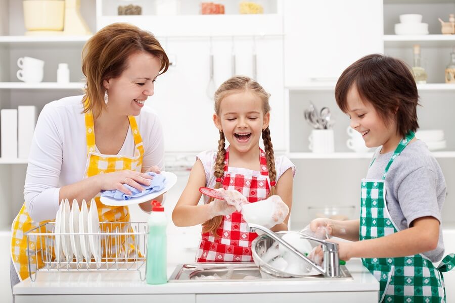 Kids and mother washing dishing and doing chores