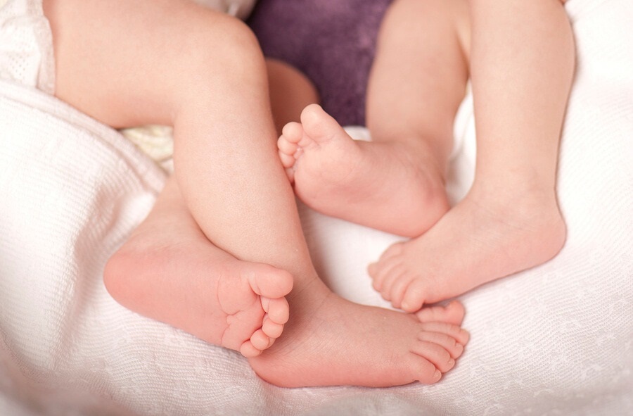 Close up for two pairs of baby feet
