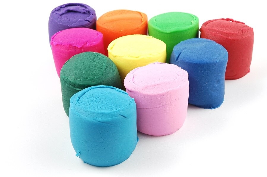 Colored play dough on white background
