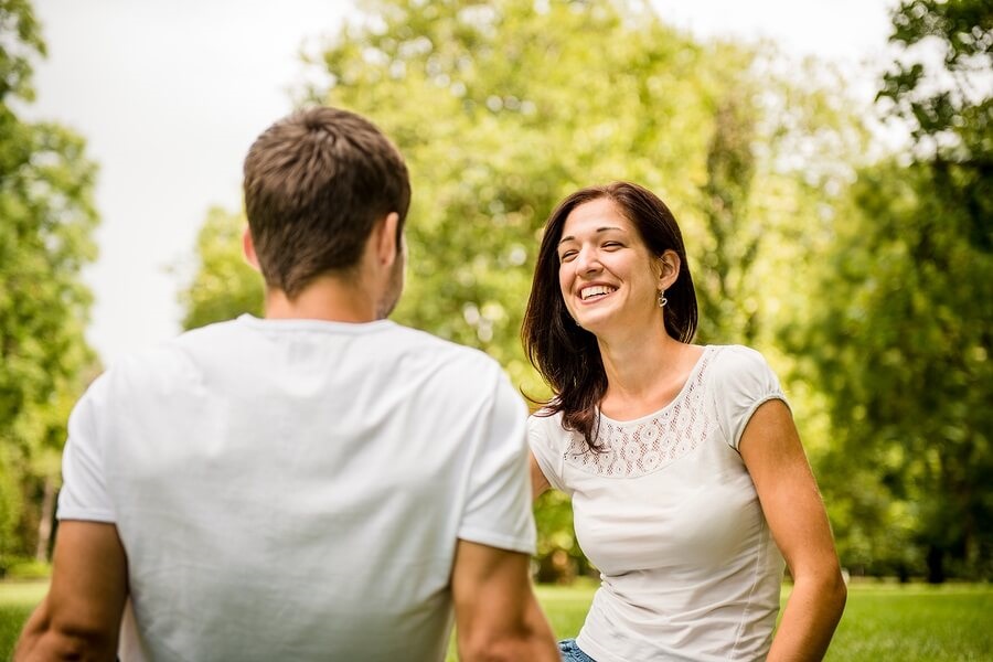 Couple sitting in park talking