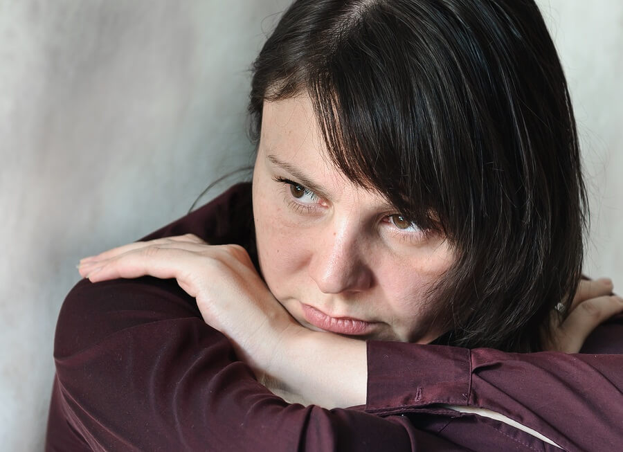 Close up of sad woman against gray background