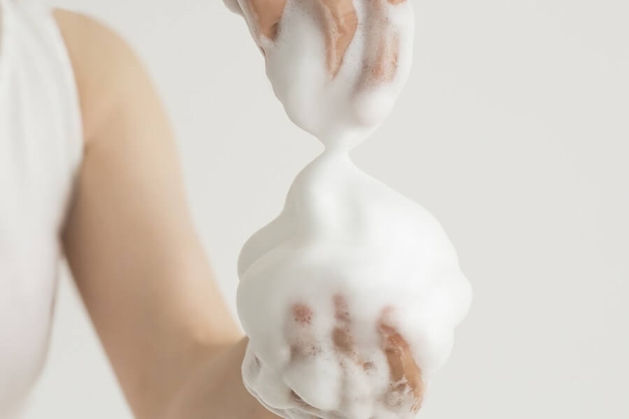 Pile of soapy foam in hands