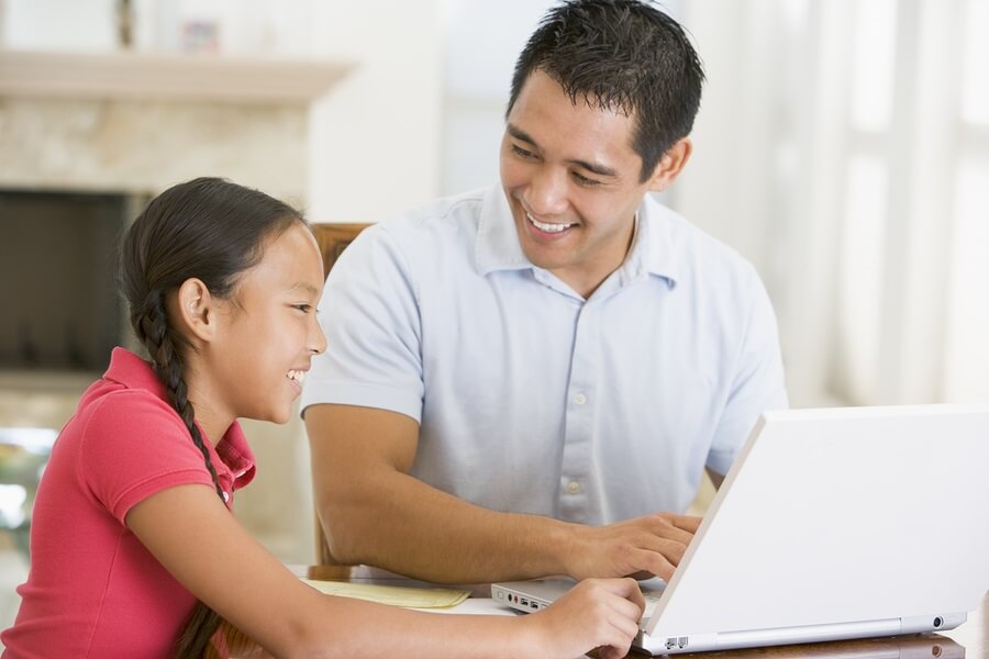 Father and Daughter Using Laptop