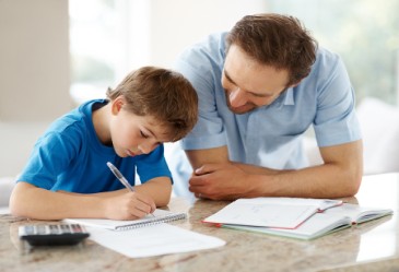 Father helping his young son with homework