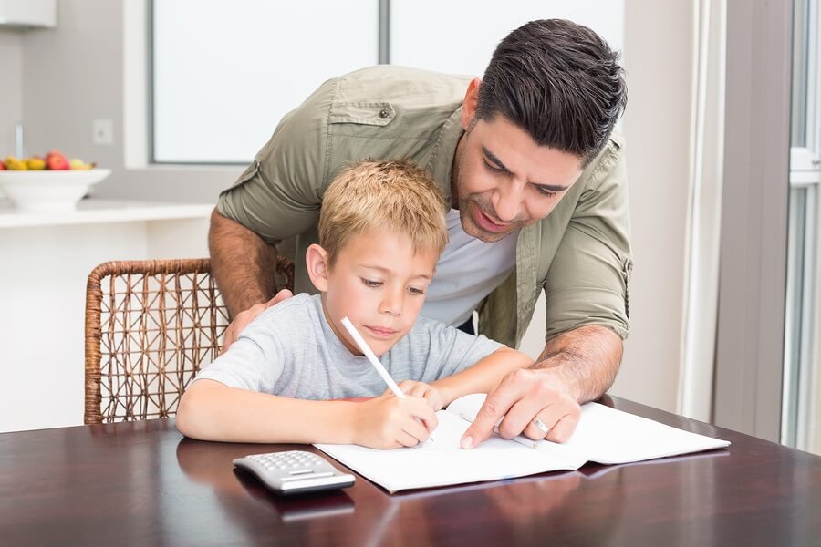 Father Helping Son with Homework in Kitchen