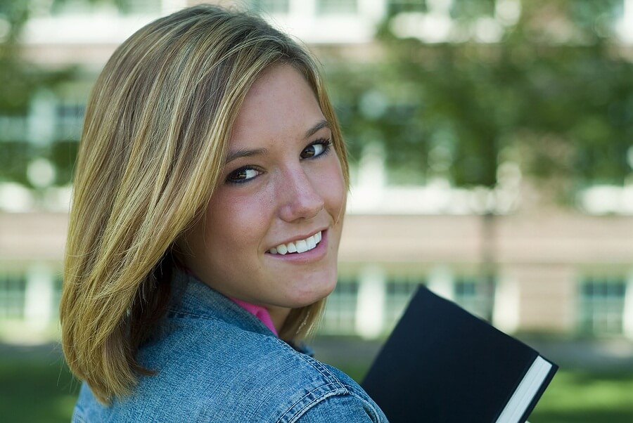 Close up of female high school student with book