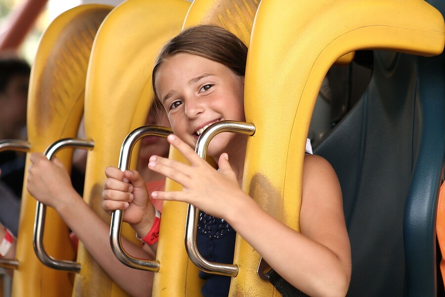 Close up of smiling girl on roller coaster