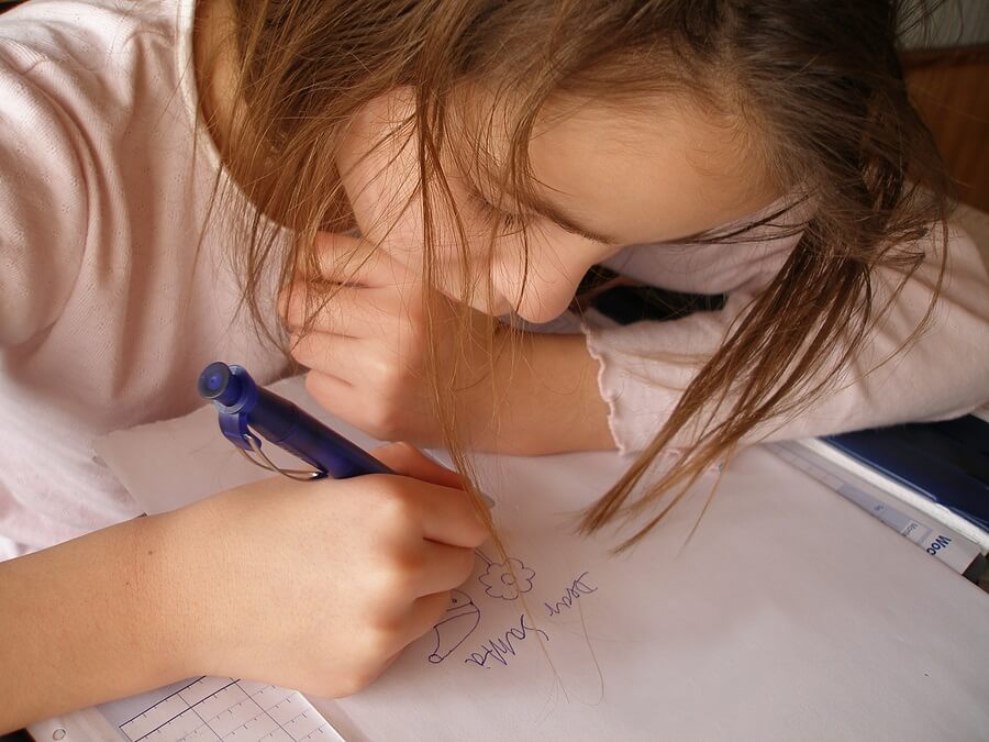 Closeup of young girl writing letter