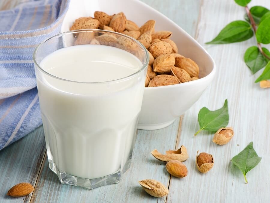 Glass of almond milk and almonds