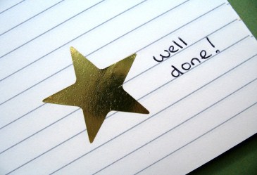 Gold star sticker on index card