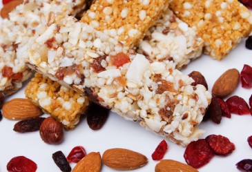 Closeup of granola bars mixed with dried fruit, nuts, and coconut.