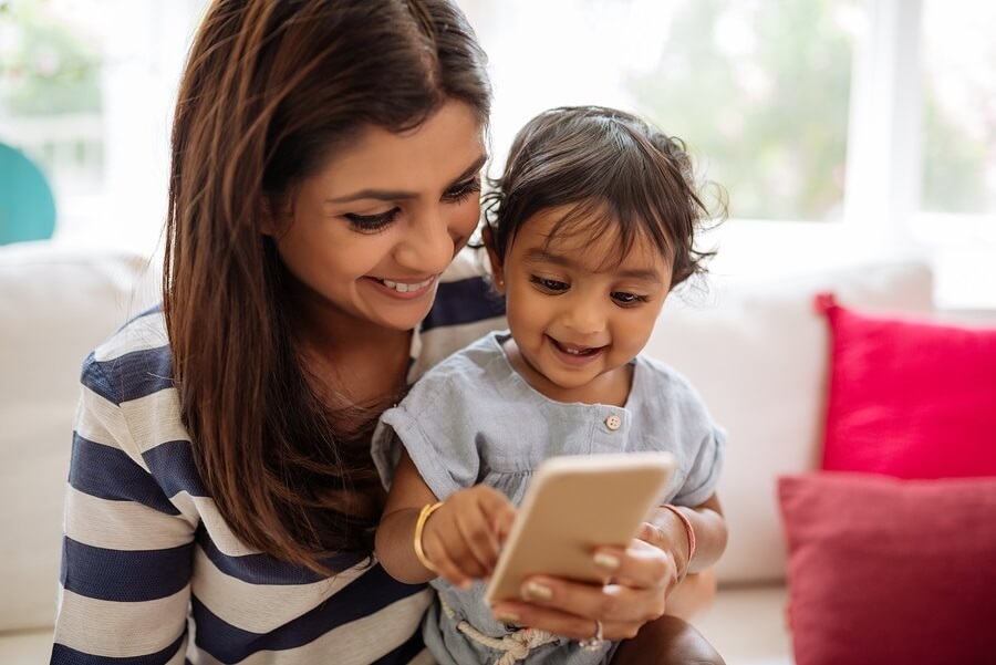 Indian mother and child playing on smartphone