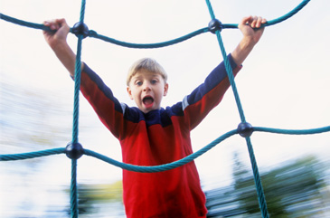 Boy climbing net