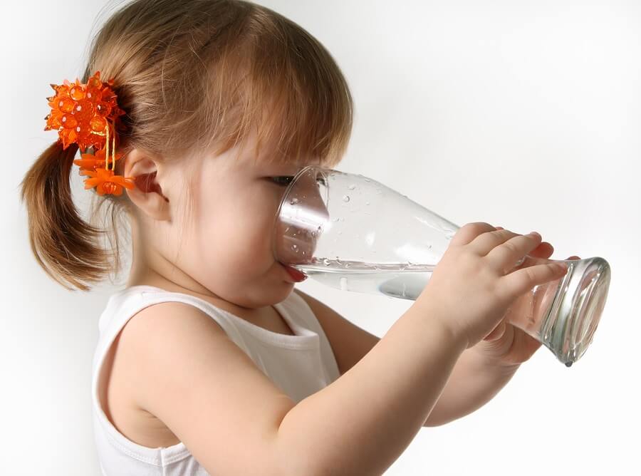 Little girl drinking glass of water