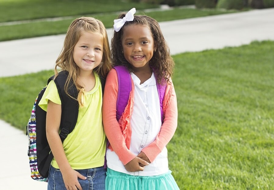 Two little girls walking to school
