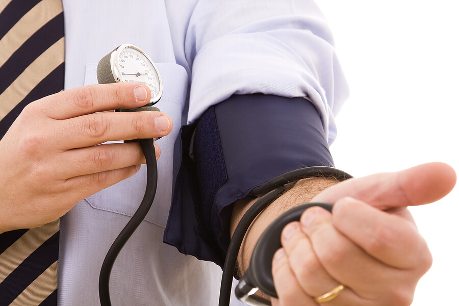 Keeping Your Husband Healthy, Man checking his own blood pressure to stay healthy
