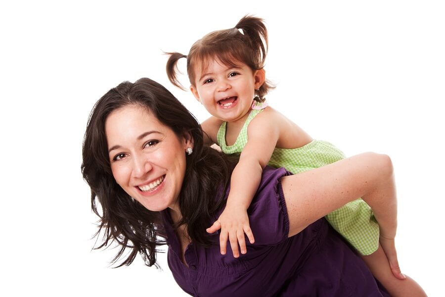 Mom giving daughter piggyback ride