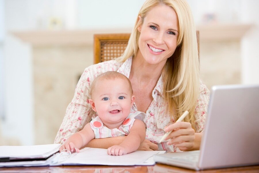 Mom sitting with baby at computer