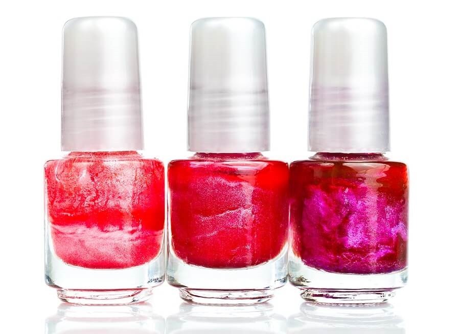 Row of nail polish bottles against white background