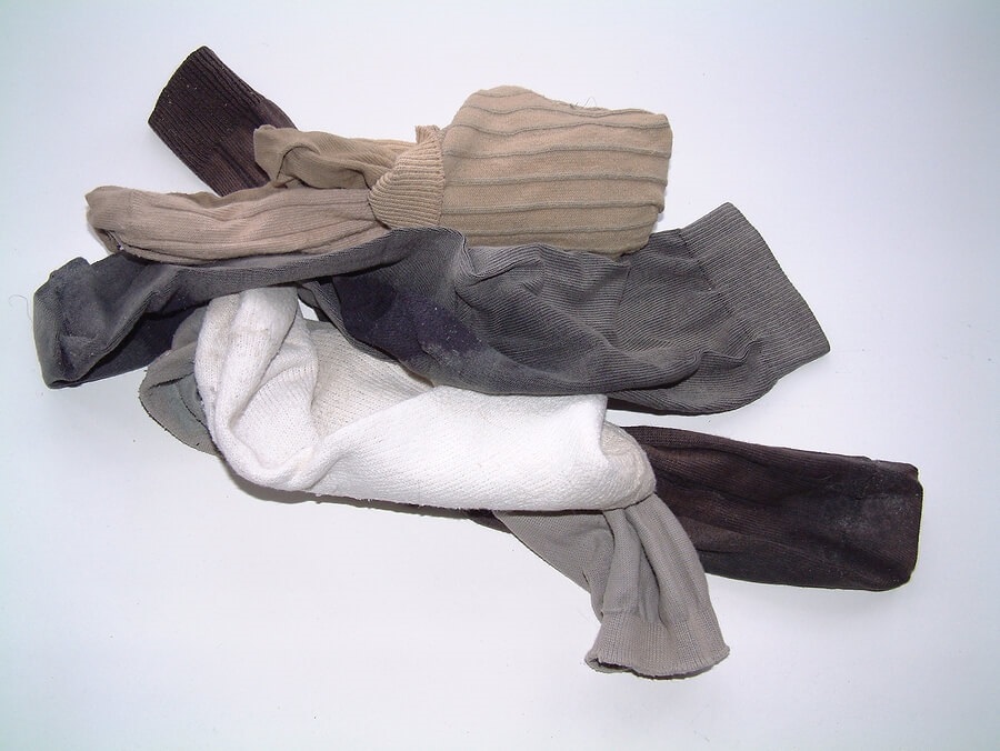 Pile of sock and laundry against white background
