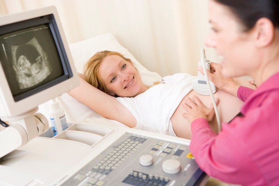 Woman getting pregnancy ultrasound