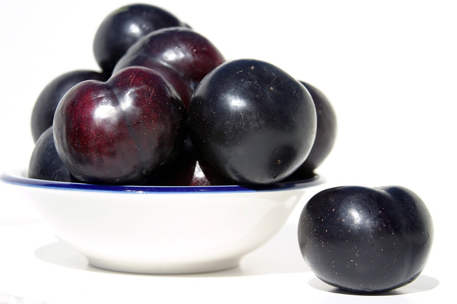 Purple plums in bowl