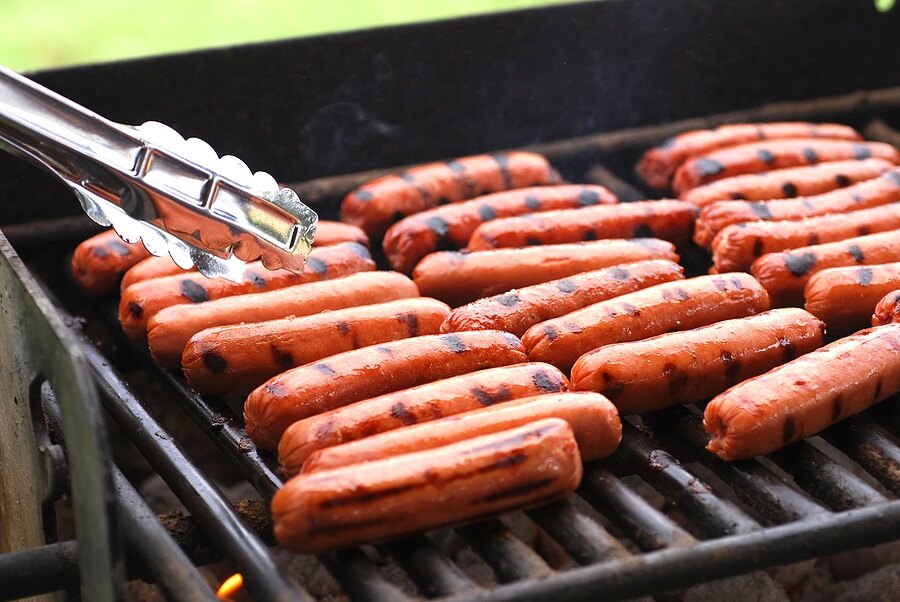 Rows of hot dogs on the grill