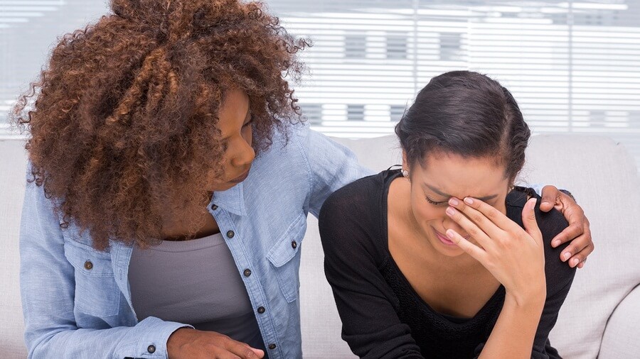 Sad woman crying to friend