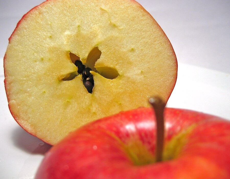 Apple cut in half, revealing a star.