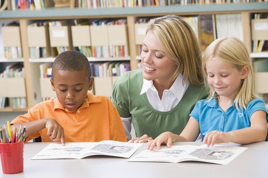 Young students reading with teacher