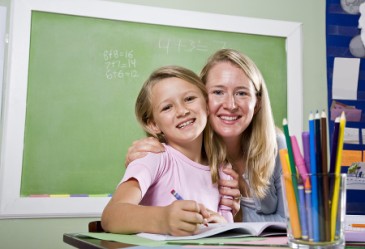Student and teacher smiling in classroom