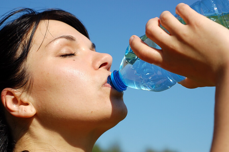 Close up of woman drinking out of water bottle