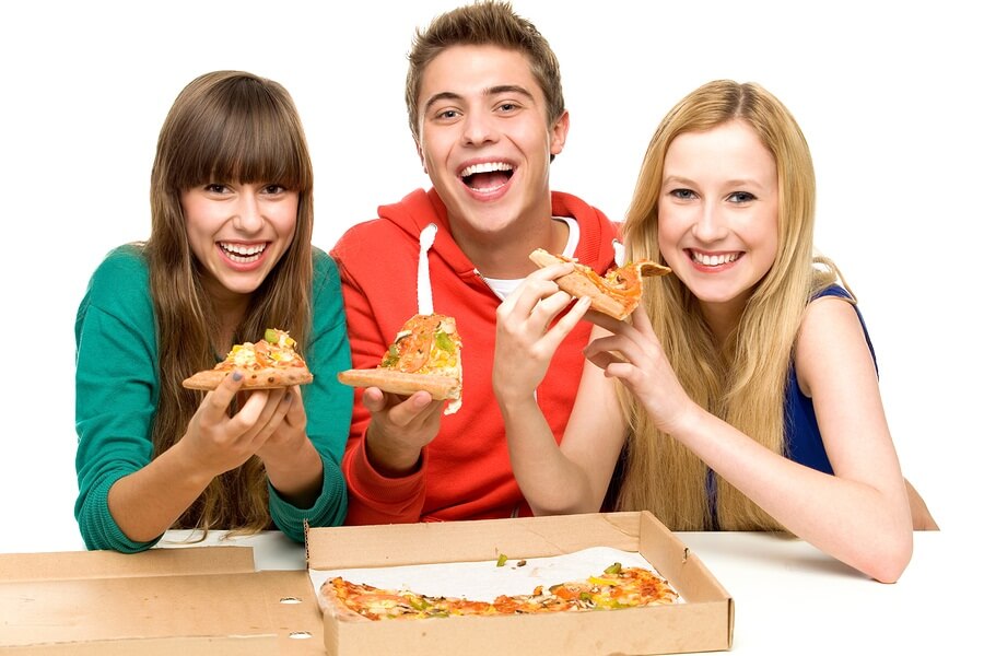 Three friends eating pizza