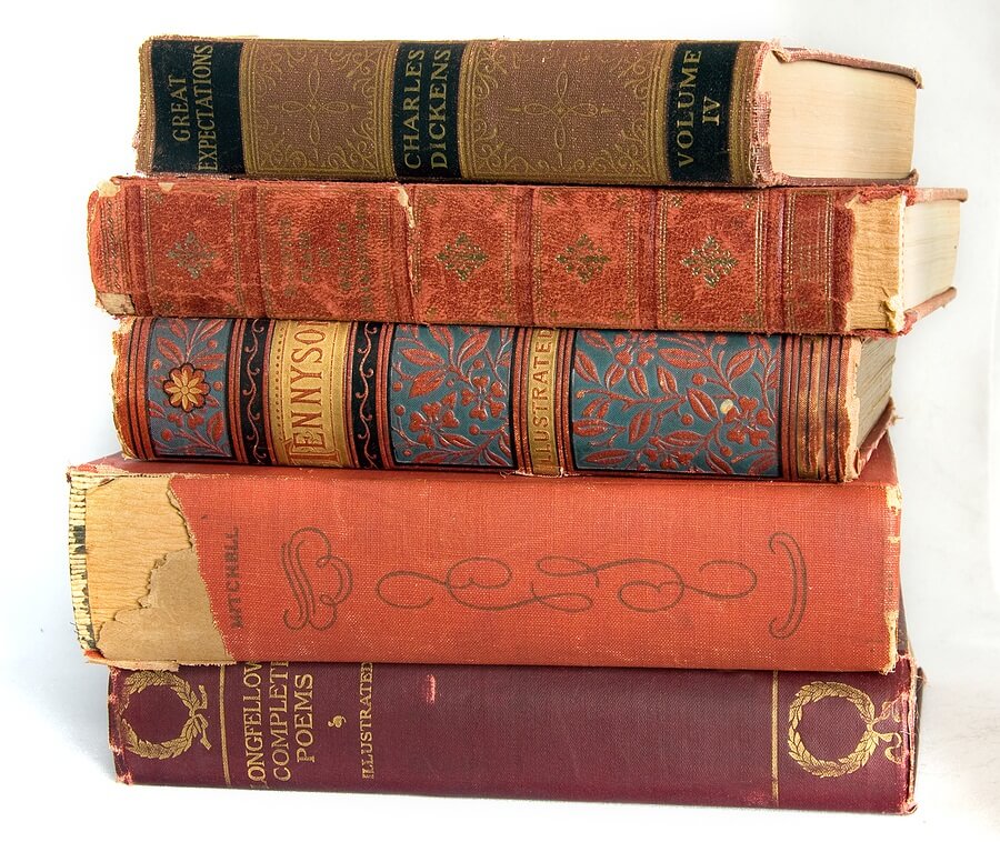 Pile of old books against white background