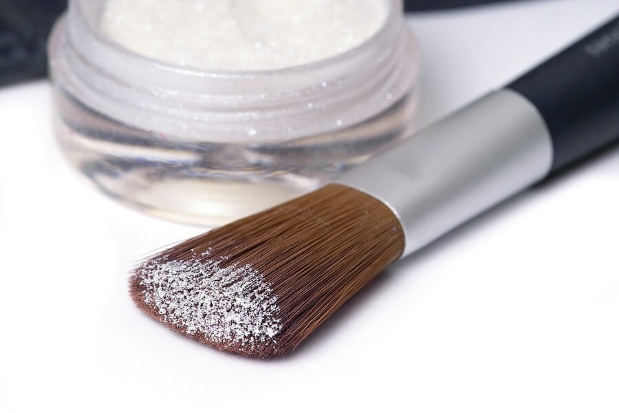 Close up of makeup brush with white face powder